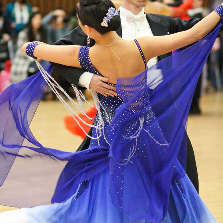 man and woman dancing at a competition